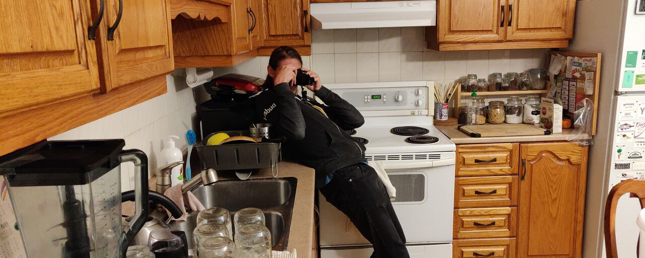 Val taking a photo in a kitchen