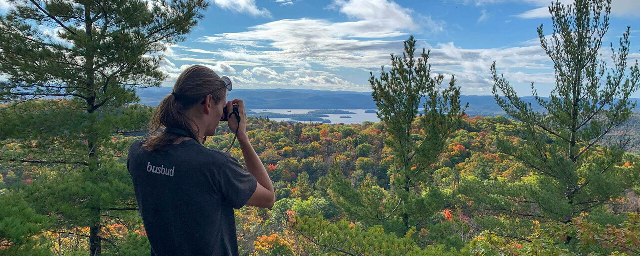 Val taking a picture on top of a mountain